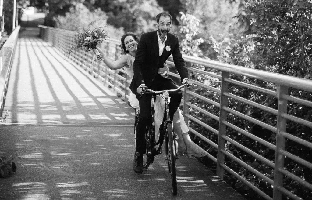 Brautpaar fährt zu zweit auf Fahrra